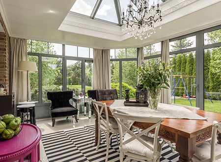 Sunroom with dining table and chandelier