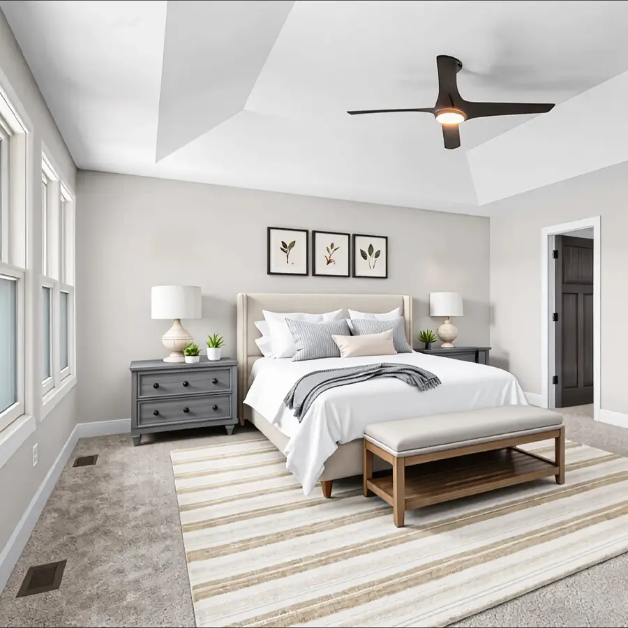 Modern bedroom with a vaulted ceiling, upholstered bed, matching nightstands, striped area rug, and a ceiling fan above.