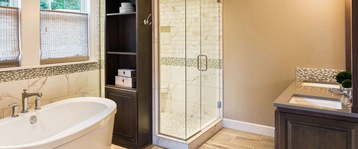 Contemporary bathroom design featuring a glass-enclosed walk-in shower with mosaic tile accents, a soaking tub, and dark wood storage shelving.