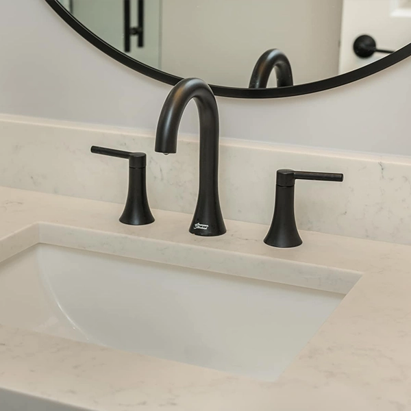 Modern undermount sink with quartz countertop and matte black widespread faucet.