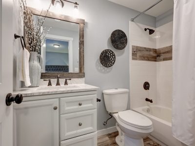 white bathroom with sink, bath, and toilet