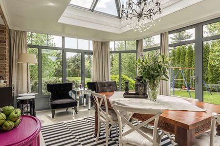 Sunroom with dining table and chandelier